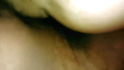 Brunette in a black dress fumbles around in her bedroom