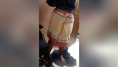 Amateur girl plays with her camera and eyes on a black chair