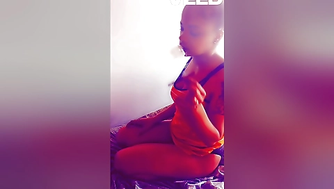 Sexy brunette smoking a cigarette and giving a blowjob